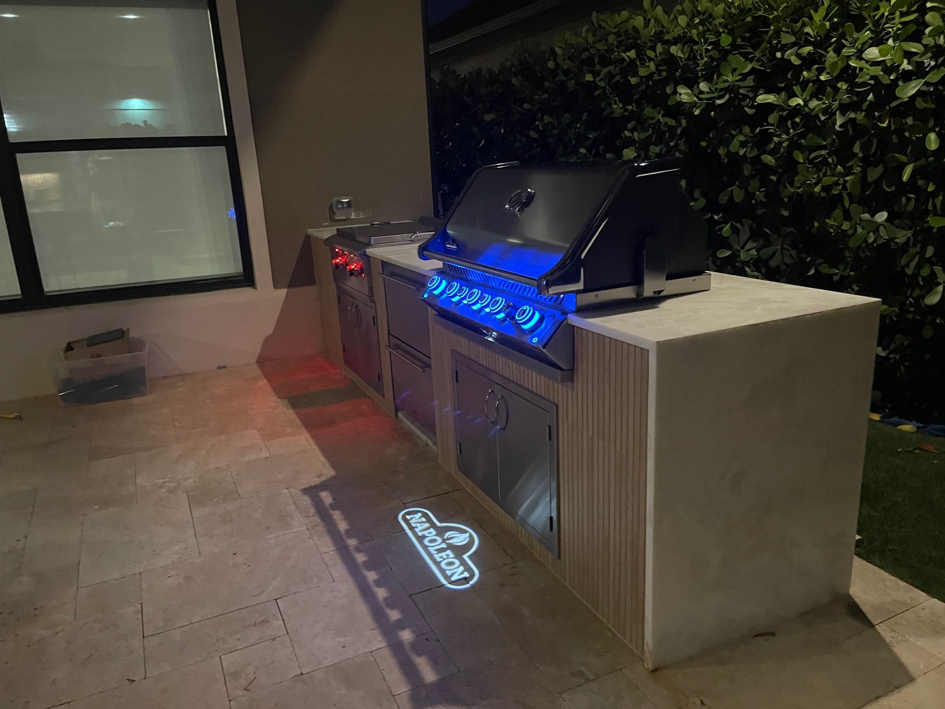 A grill is sitting on top of a counter next to a window.