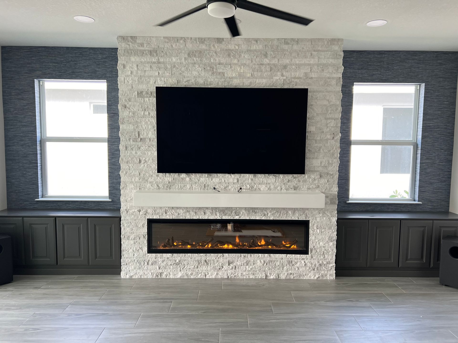A living room with a fireplace and a flat screen tv