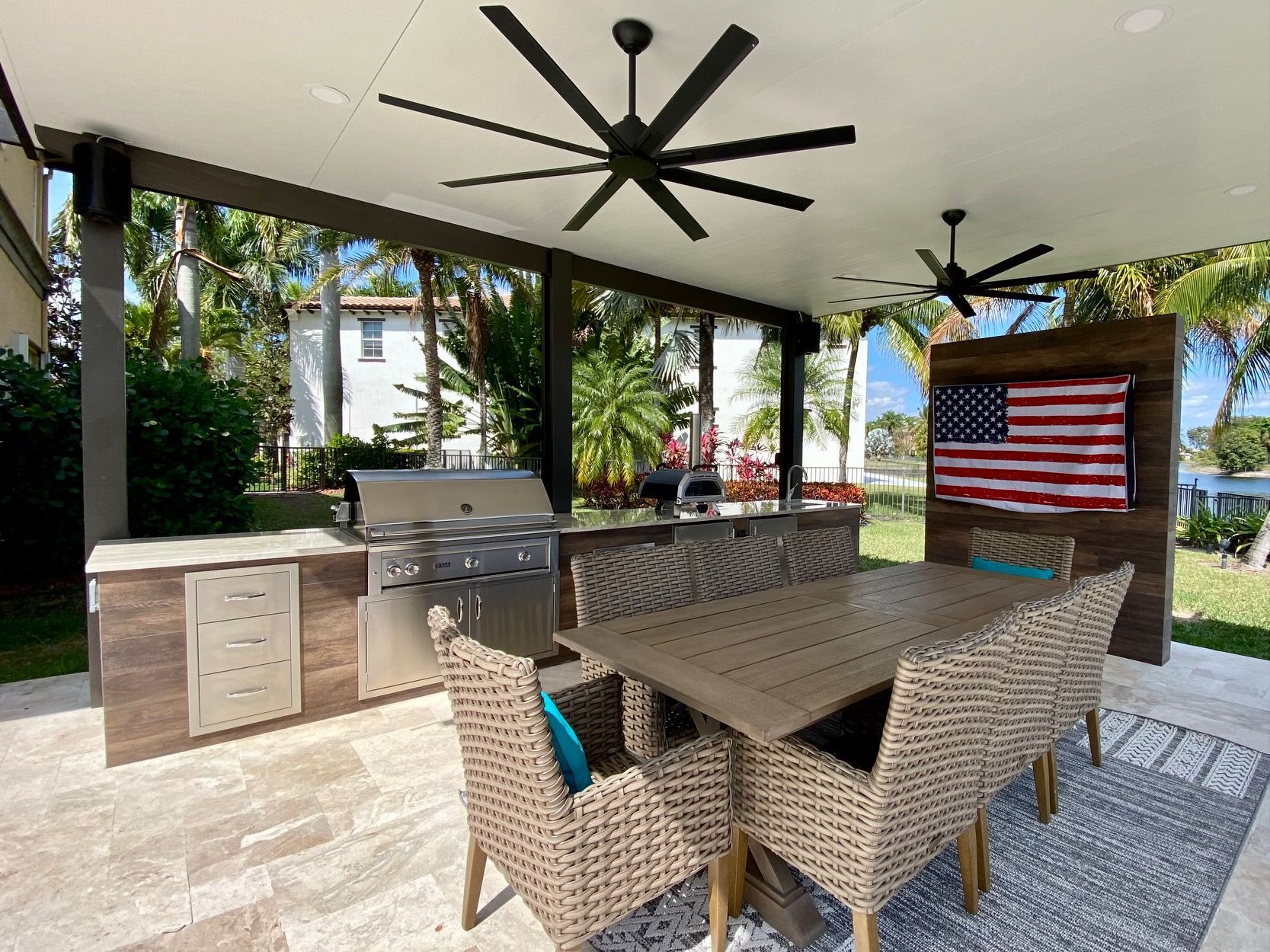 A patio with a table and chairs and a ceiling fan