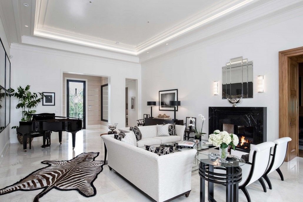 Elegant living room with a black marble fireplace and zebra-print accents in Boca Raton, FL.