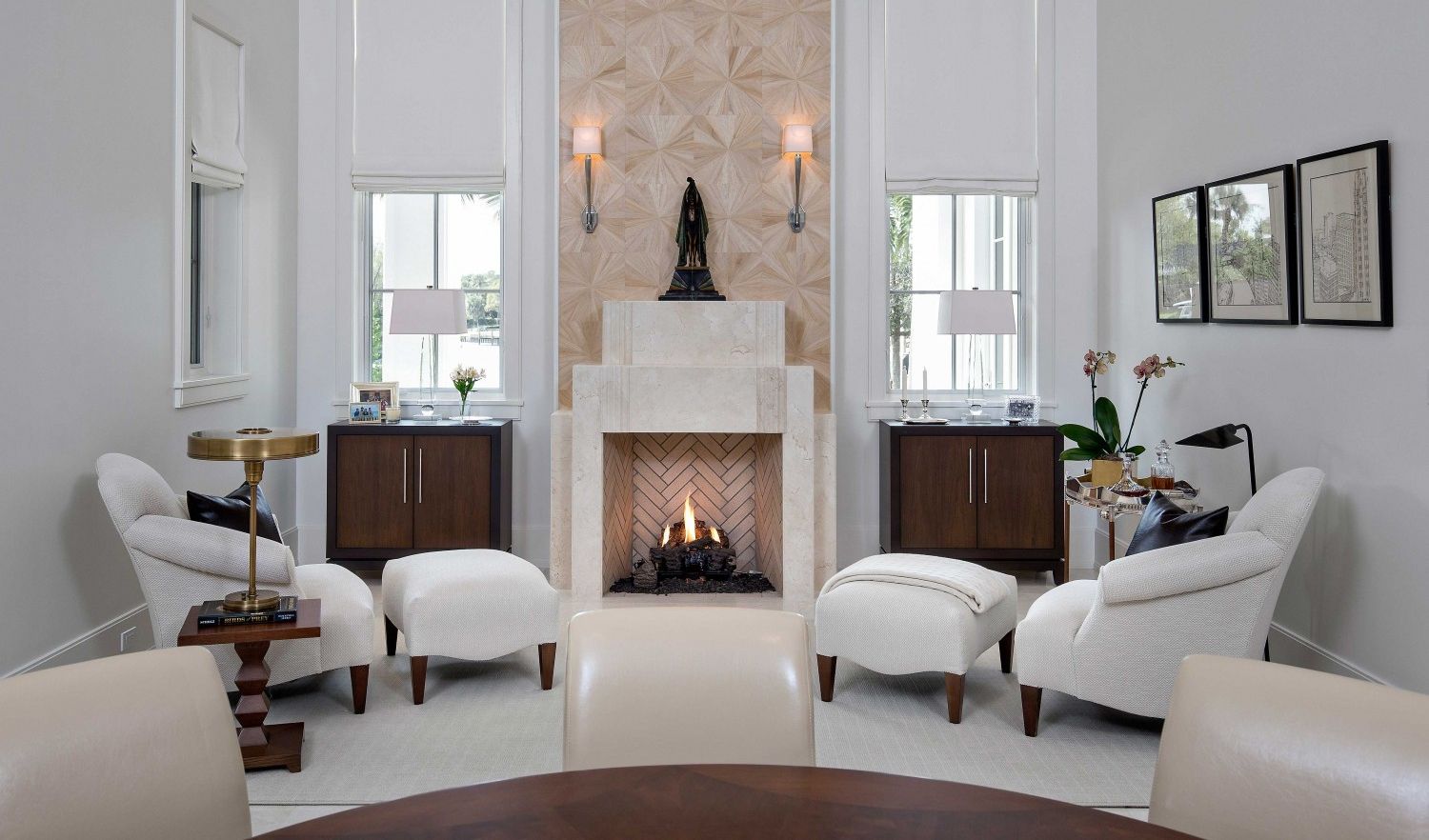 A living room with white furniture and a fireplace