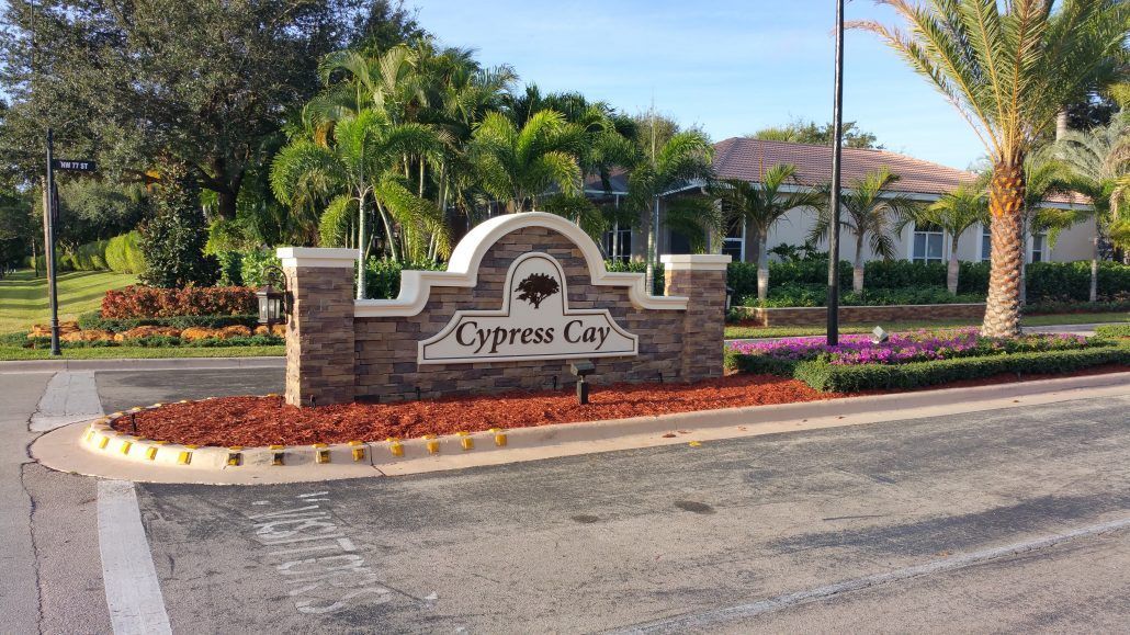 A sign for cypress city is in front of a house