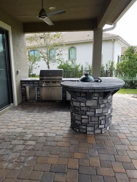 There is a grill and a table on the patio.
