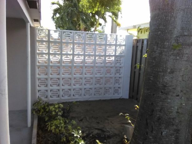 A white wall with a pattern of squares on it