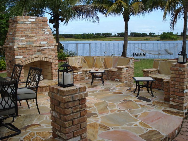There is a fireplace in the middle of the patio.