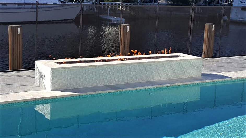 Modern linear fire feature by the poolside in Parkland, FL.