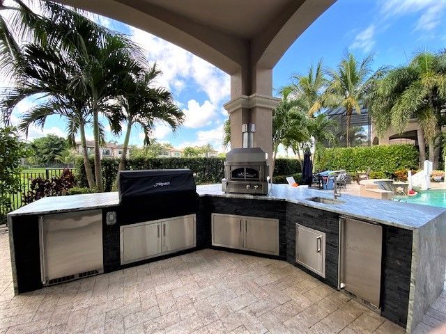 A white house with a patio and stools in front of it