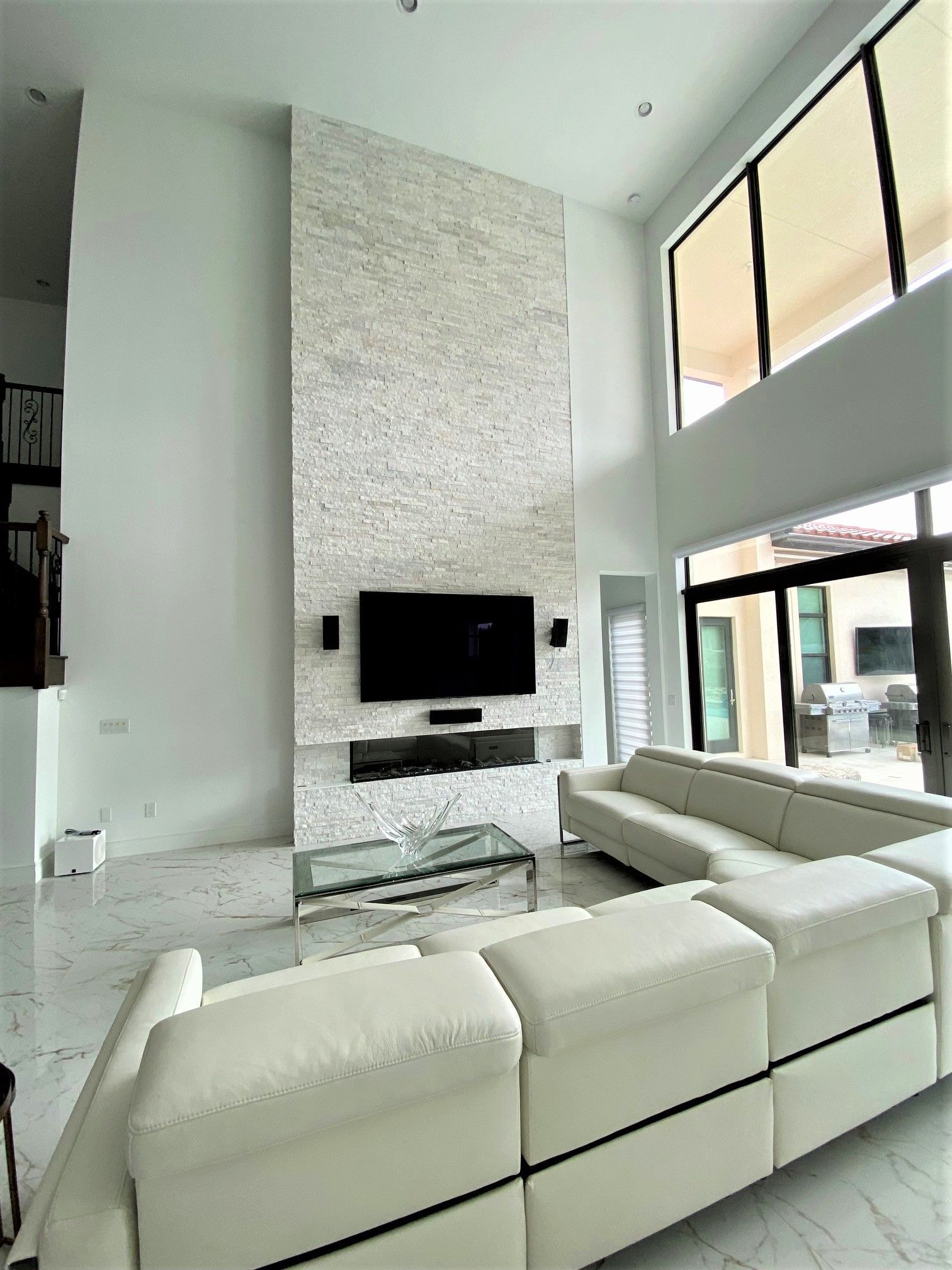 A living room with a couch , television and fireplace.