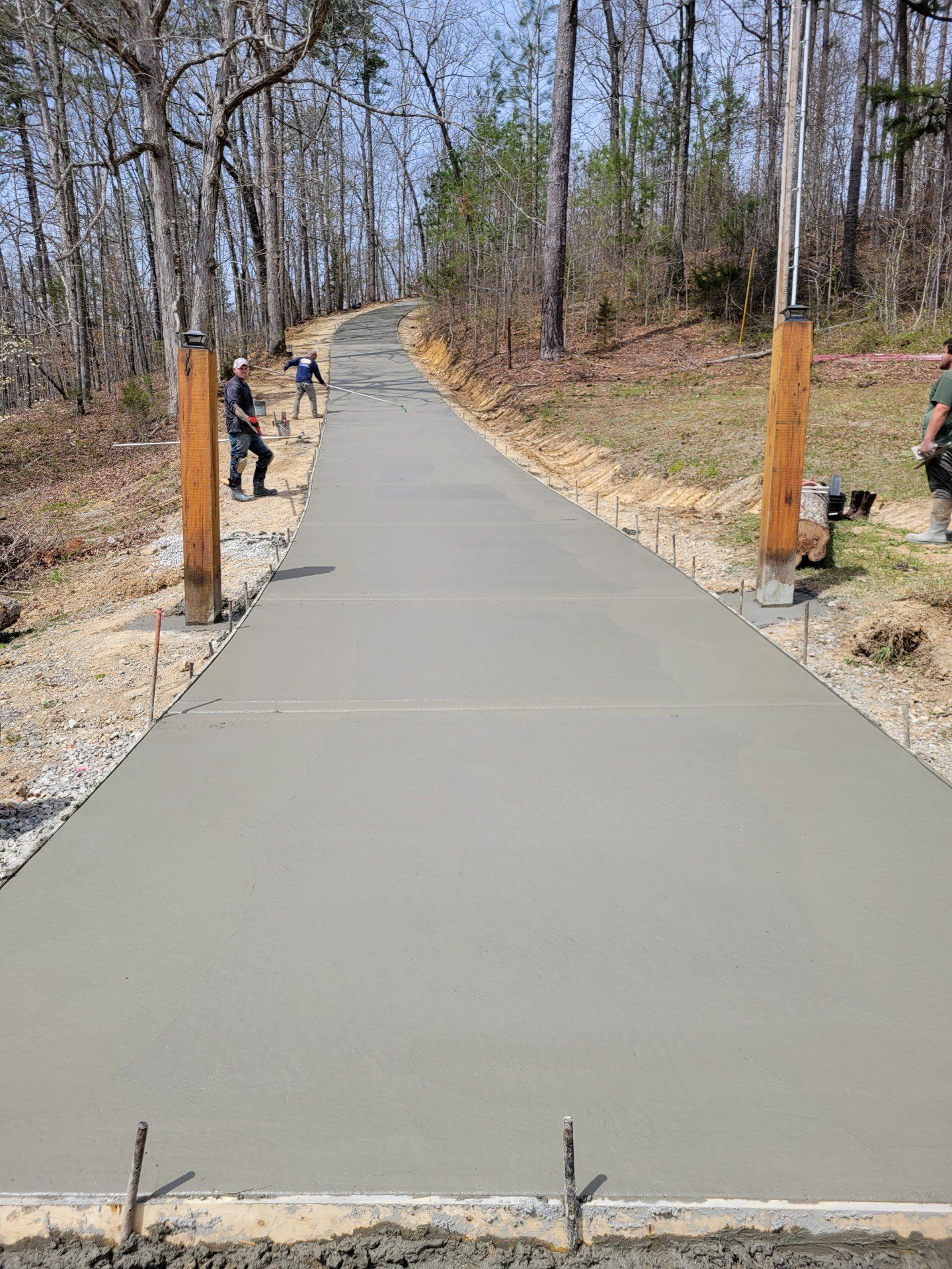 a concrete driveway is being built in the woods