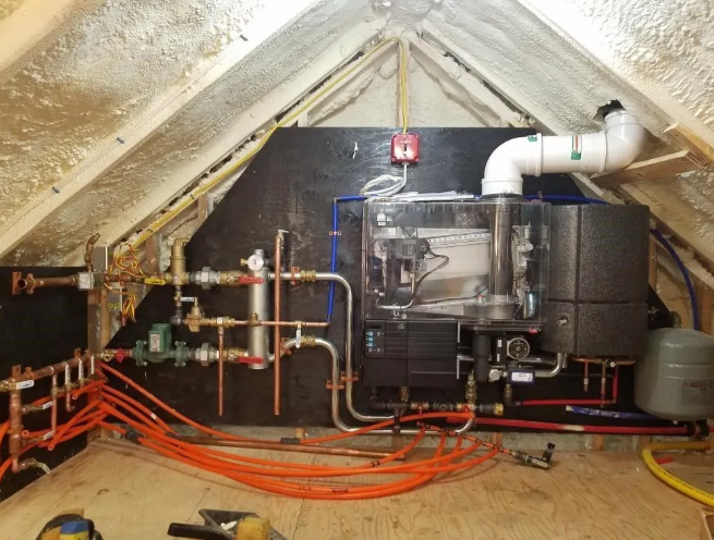 Interior view of an attic with heating system components including pipes and boiler.