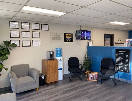 A waiting room with chairs and a water cooler.