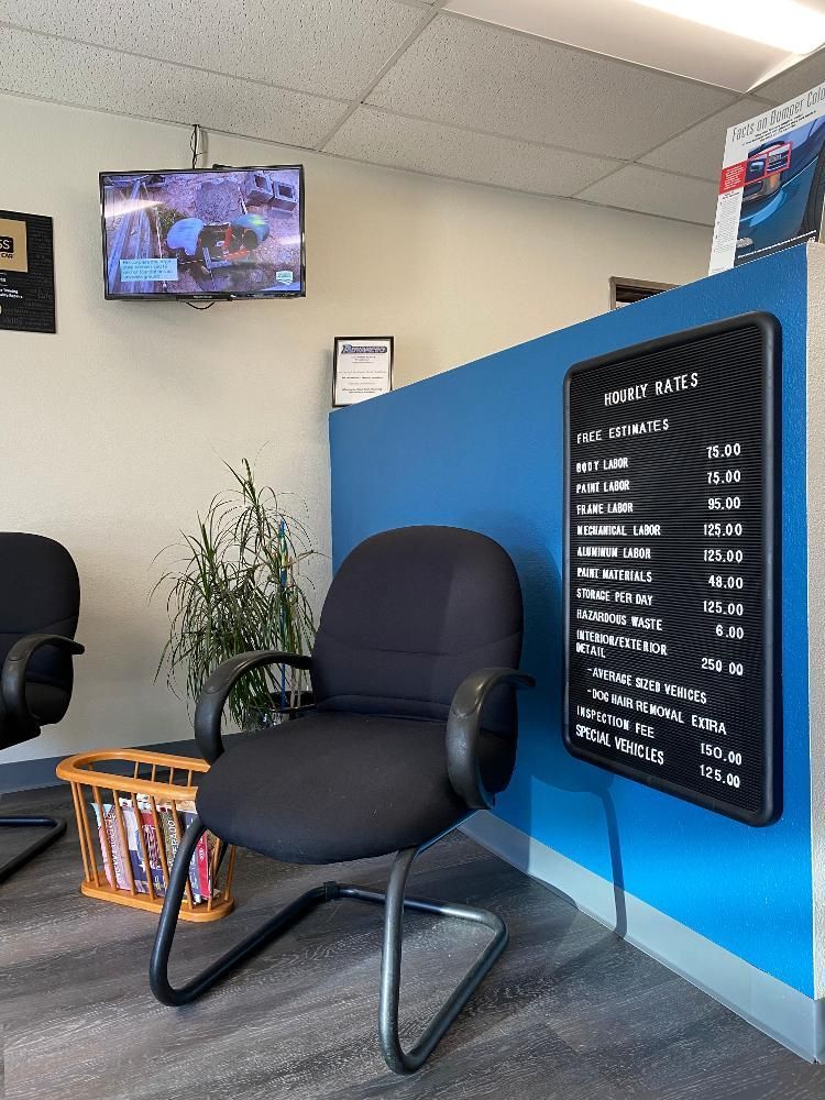 A waiting room with two chairs and a menu on the wall.
