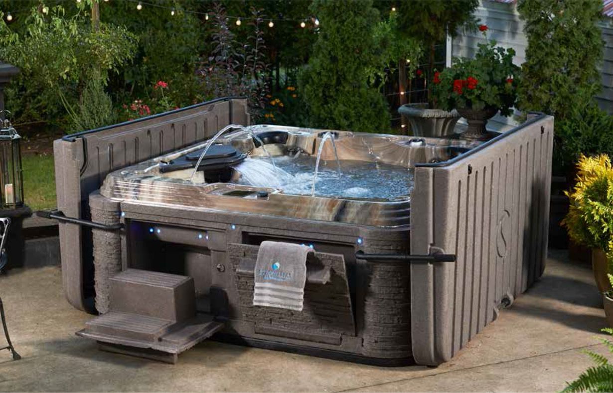 Outdoor hot tub with water jets, surrounded by wooden panels and greenery