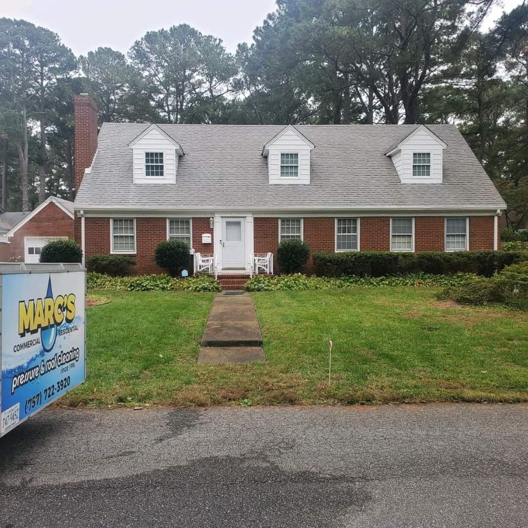 After photo of brick house with a white roof