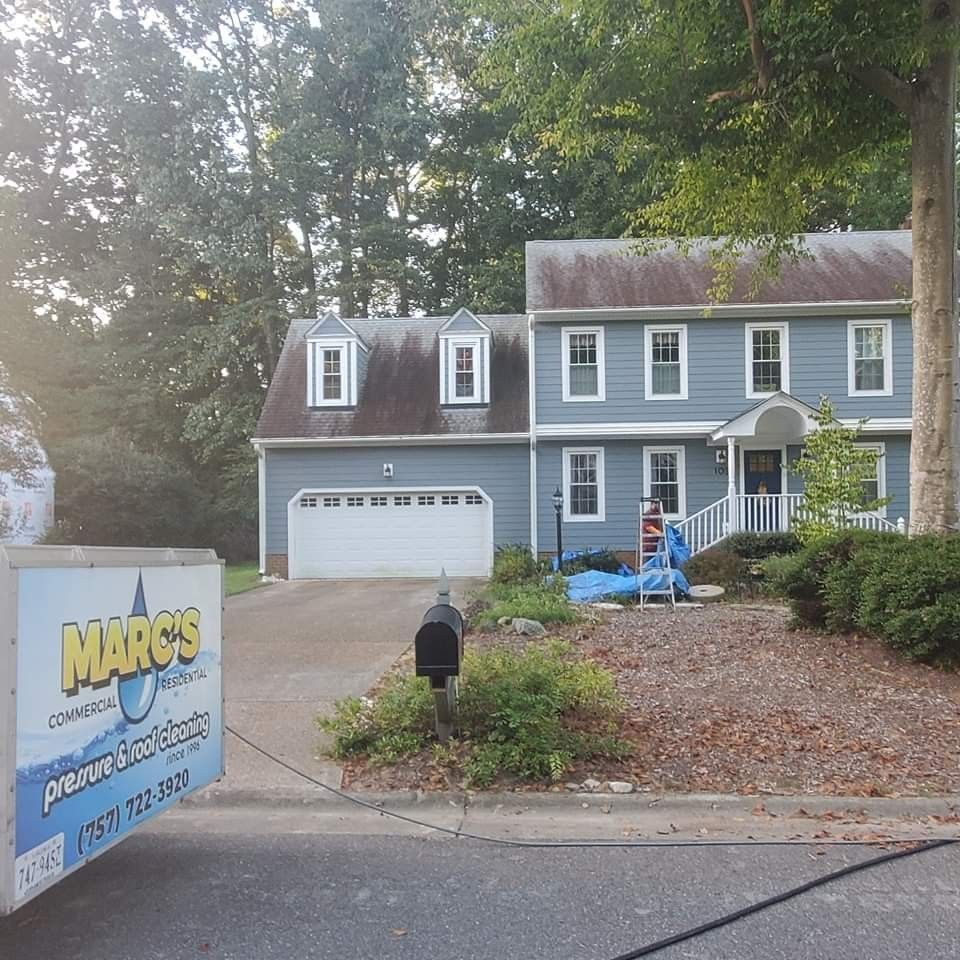 Before photo of a blue house with a mailbox and a sign