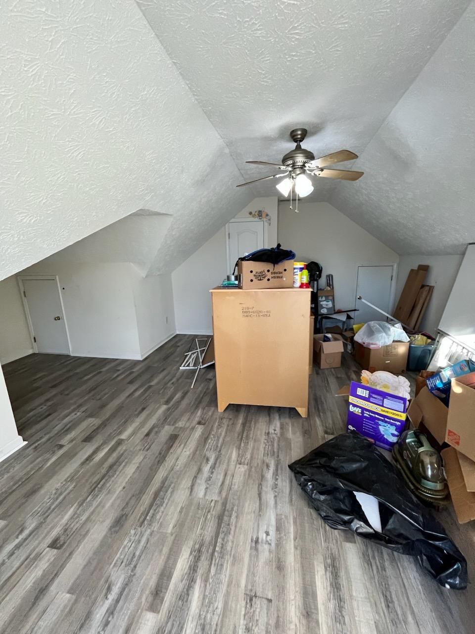 a room with vinyl flooring and a lot of boxes on the floor
