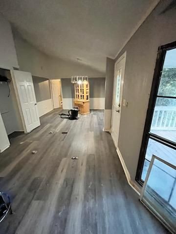 a living room with vinyl floors and a large window