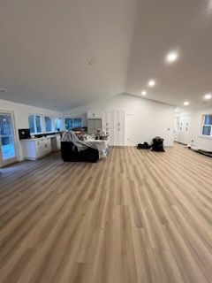 a large room with a vinyl floor and a white ceiling