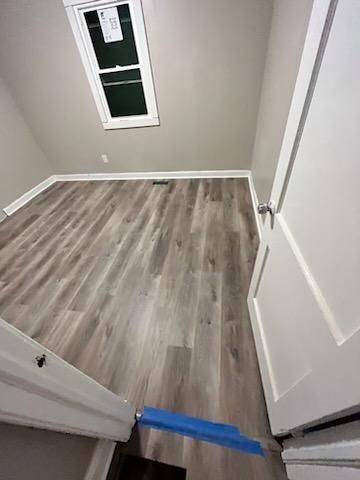 a room with vinyl floors and a window