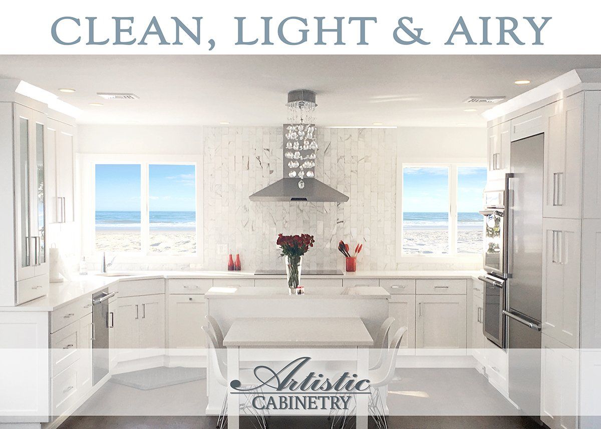 An ad for artistic cabinetry shows a kitchen with white cabinets and stainless steel appliances