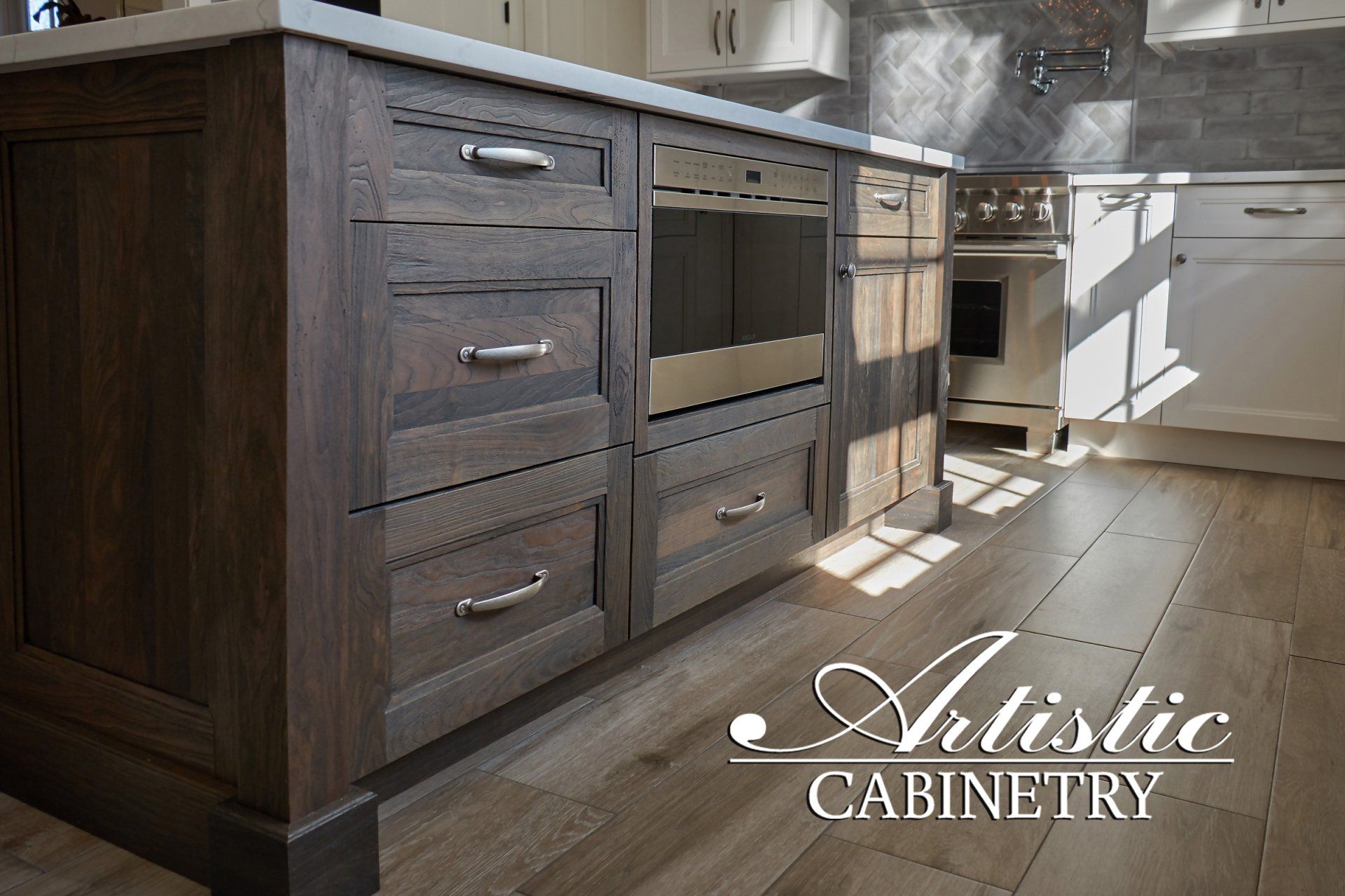 A kitchen with artistic cabinetry written on the bottom