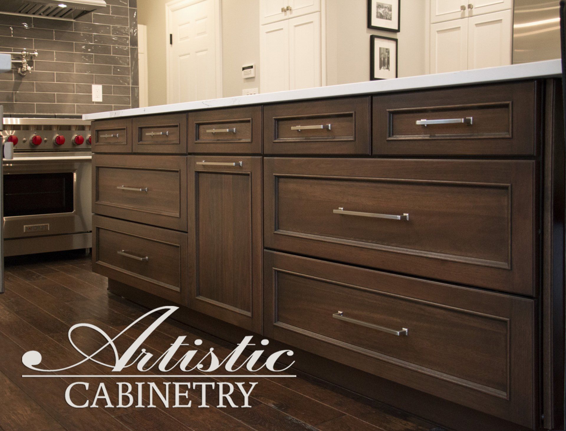 A kitchen with artistic cabinetry drawers and a stove