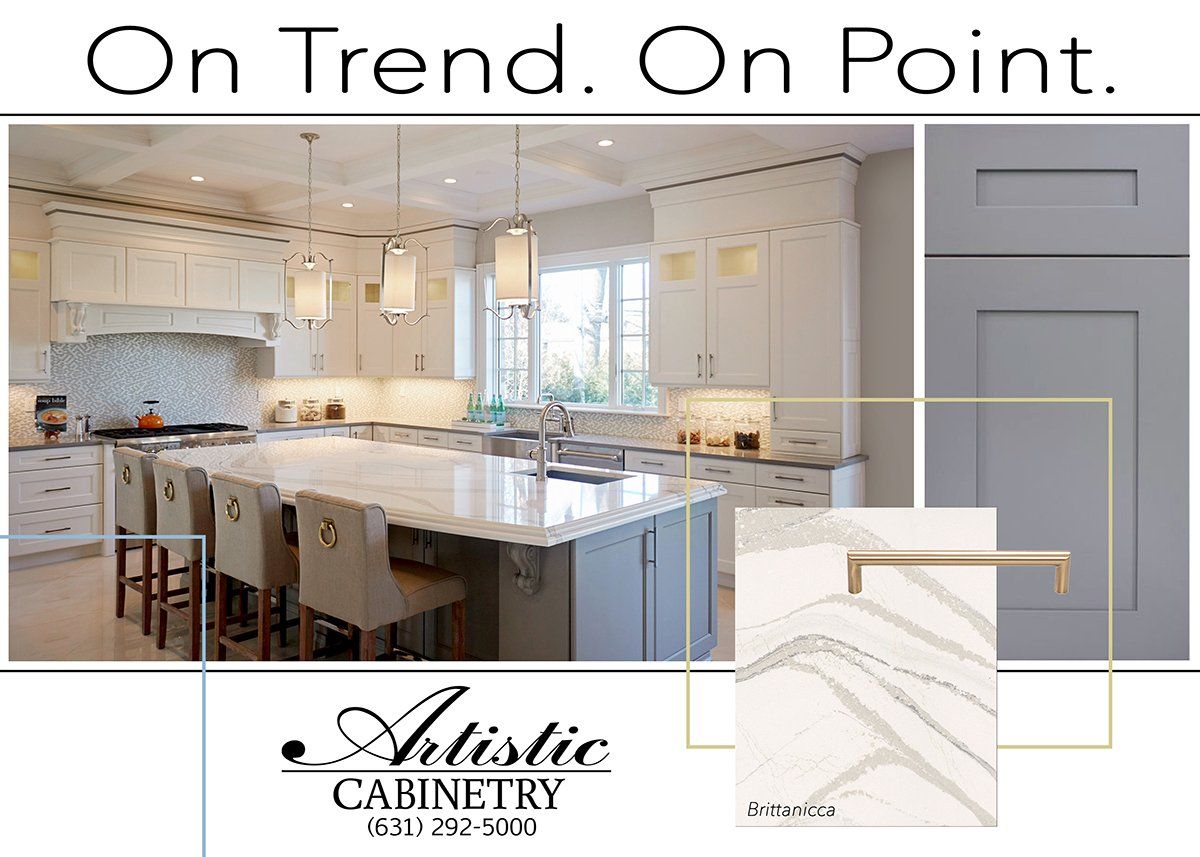 A picture of a kitchen with white cabinets and a large island.