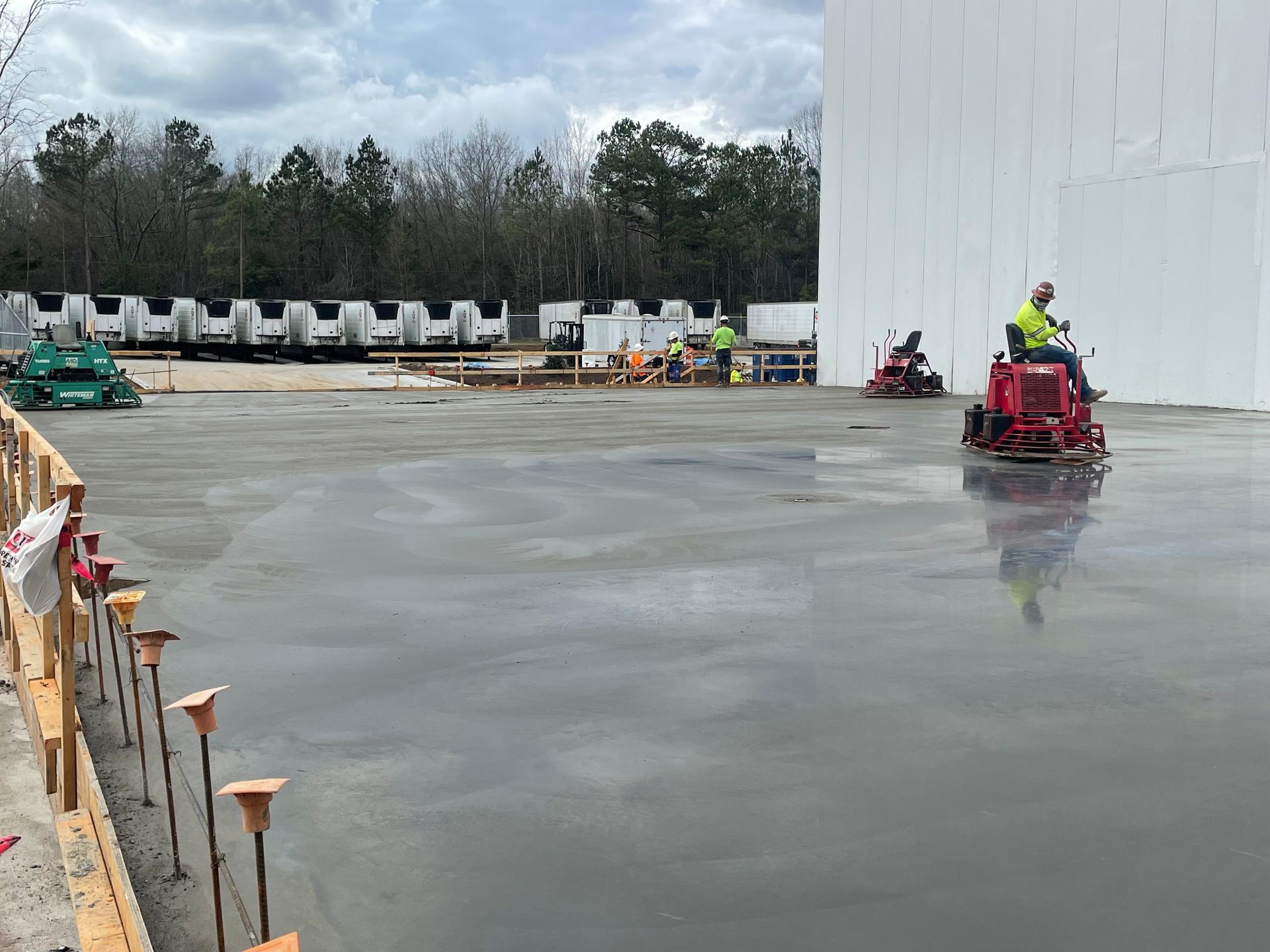 A man is riding a machine on a concrete floor.