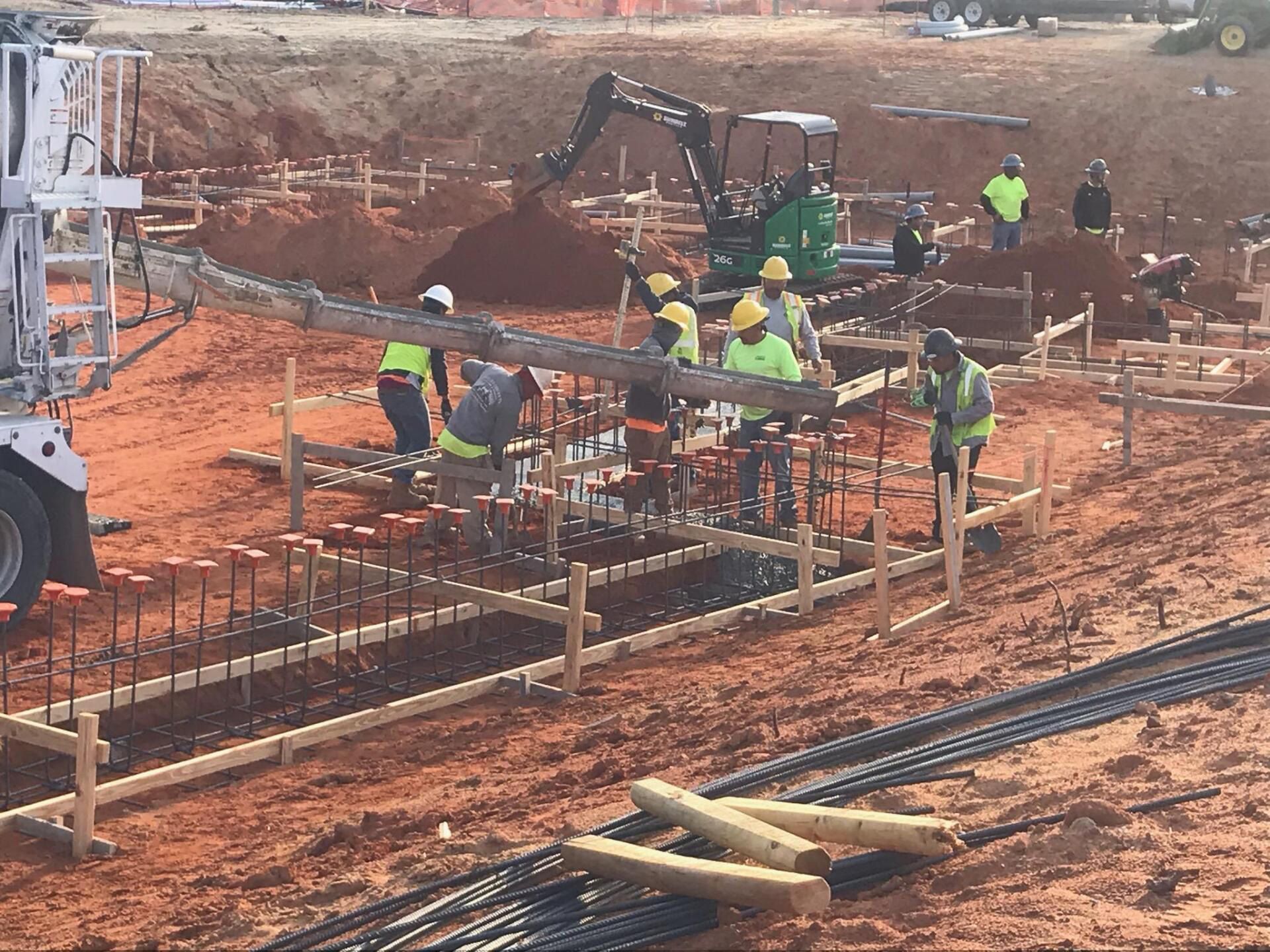 A group of construction workers are working on a construction site.