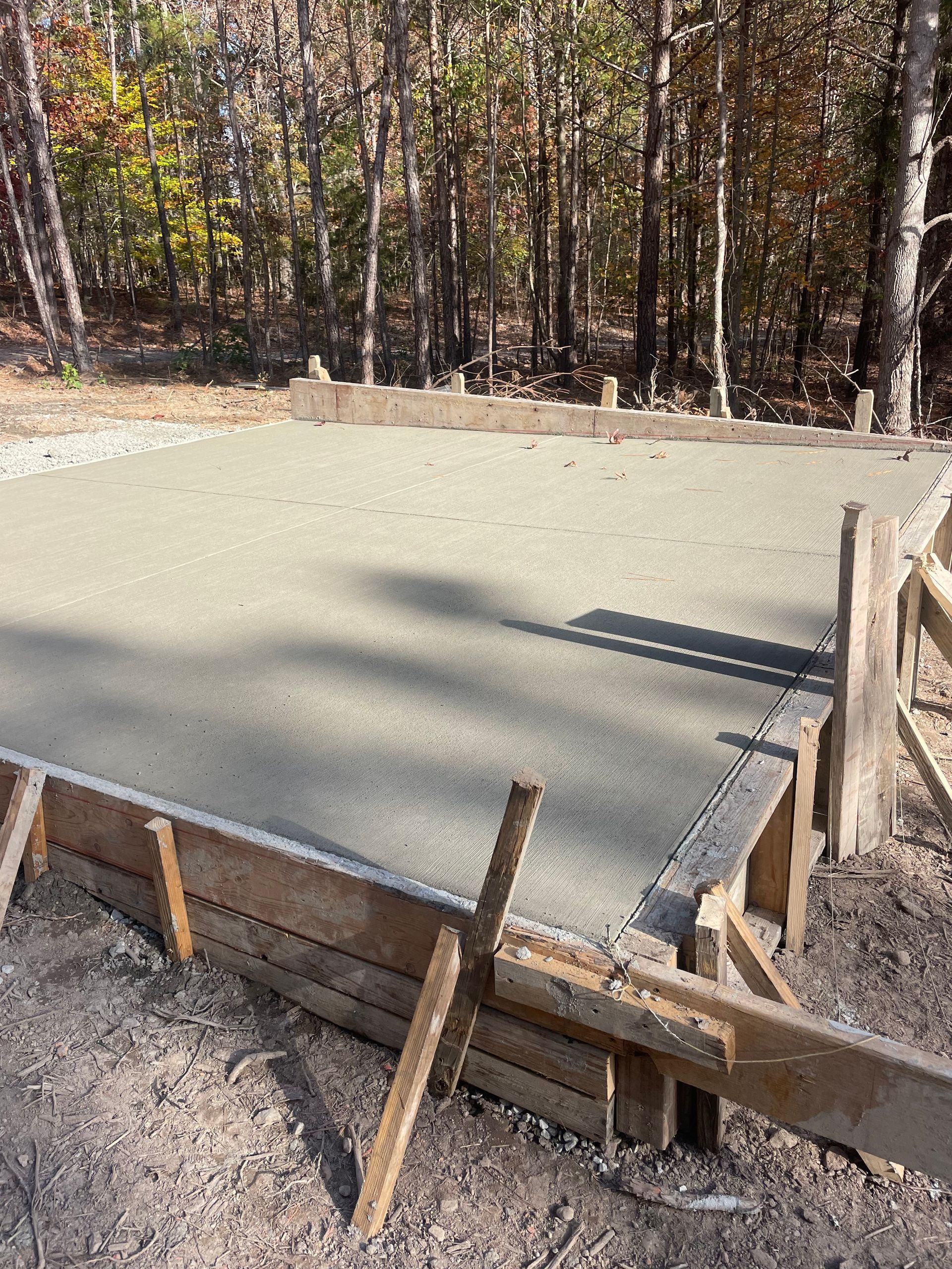 A concrete slab is being built in the middle of a forest.
