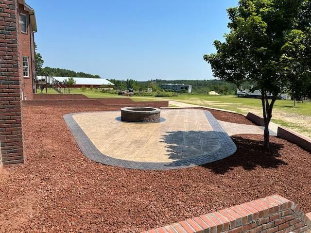 There is a fire pit in the middle of the yard.