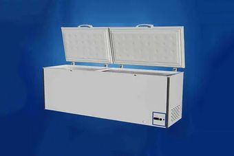 A white chest freezer with the doors open on a blue background.