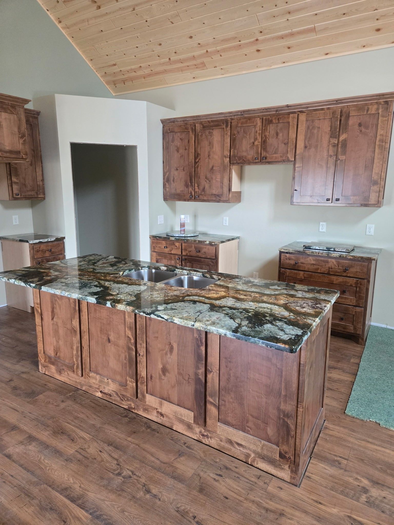 A kitchen with wooden cabinets and granite counter tops.