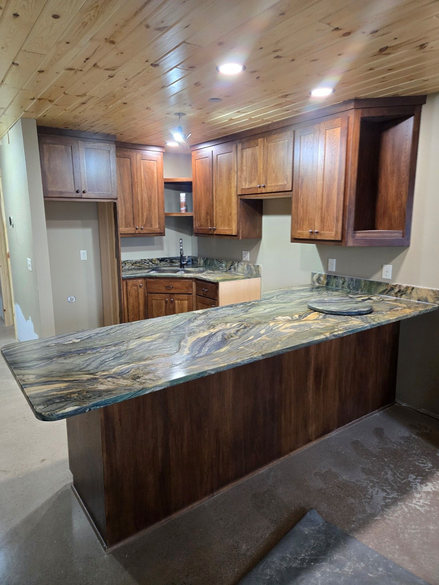 A kitchen with wooden cabinets and granite counter tops.