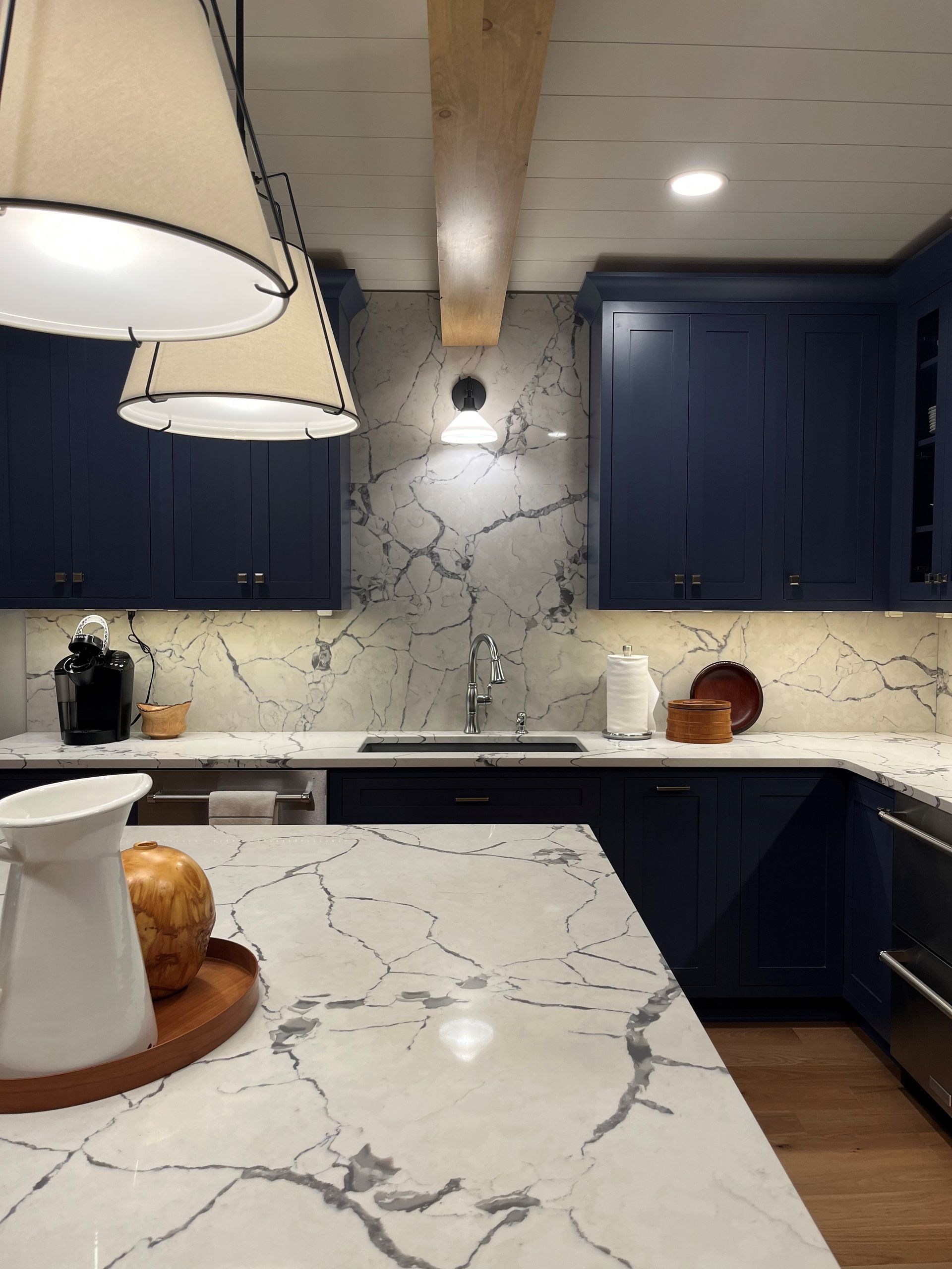 a kitchen with blue cabinets and a white counter top