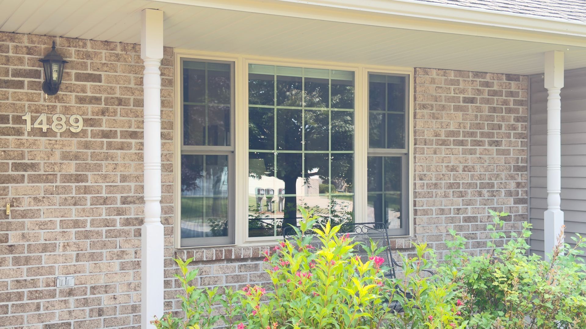 Brick house exterior with window, address 
