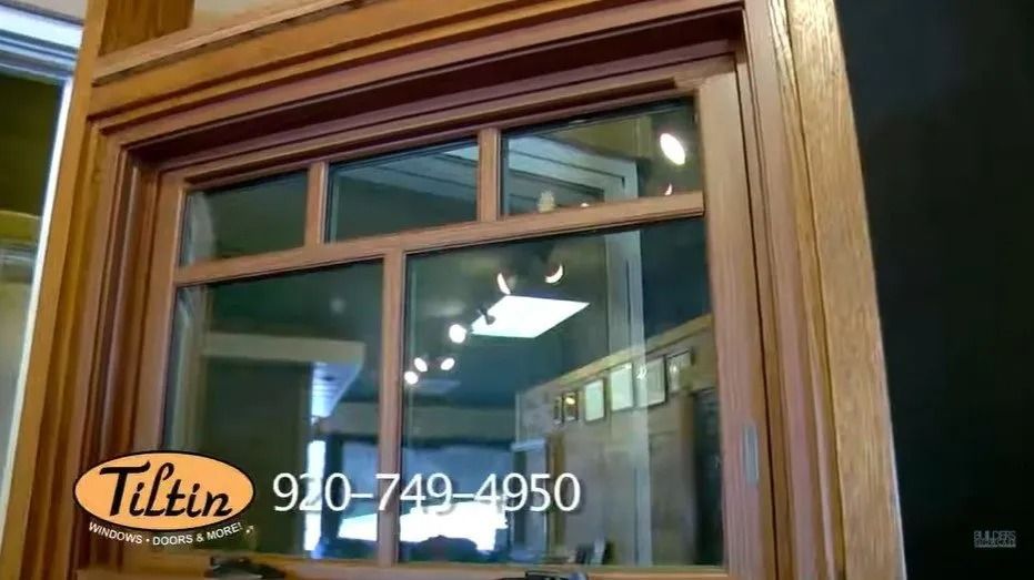 Window with a wooden frame. Interior view through the glass. Contact info: 920-749-4950, Tiltin.