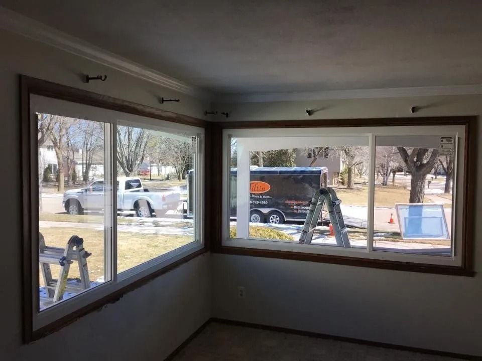 Two new windows in a room corner, with a truck and trailer visible outside.