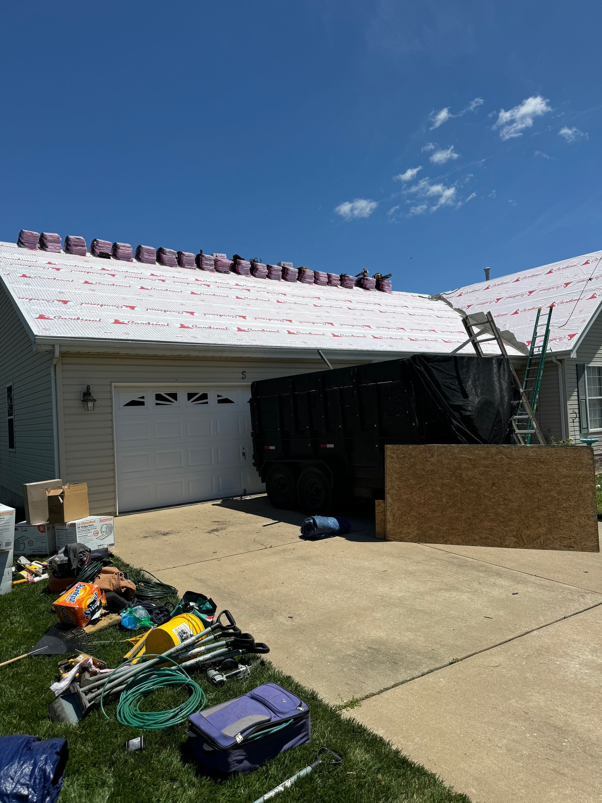 A house is being remodeled with a new roof.