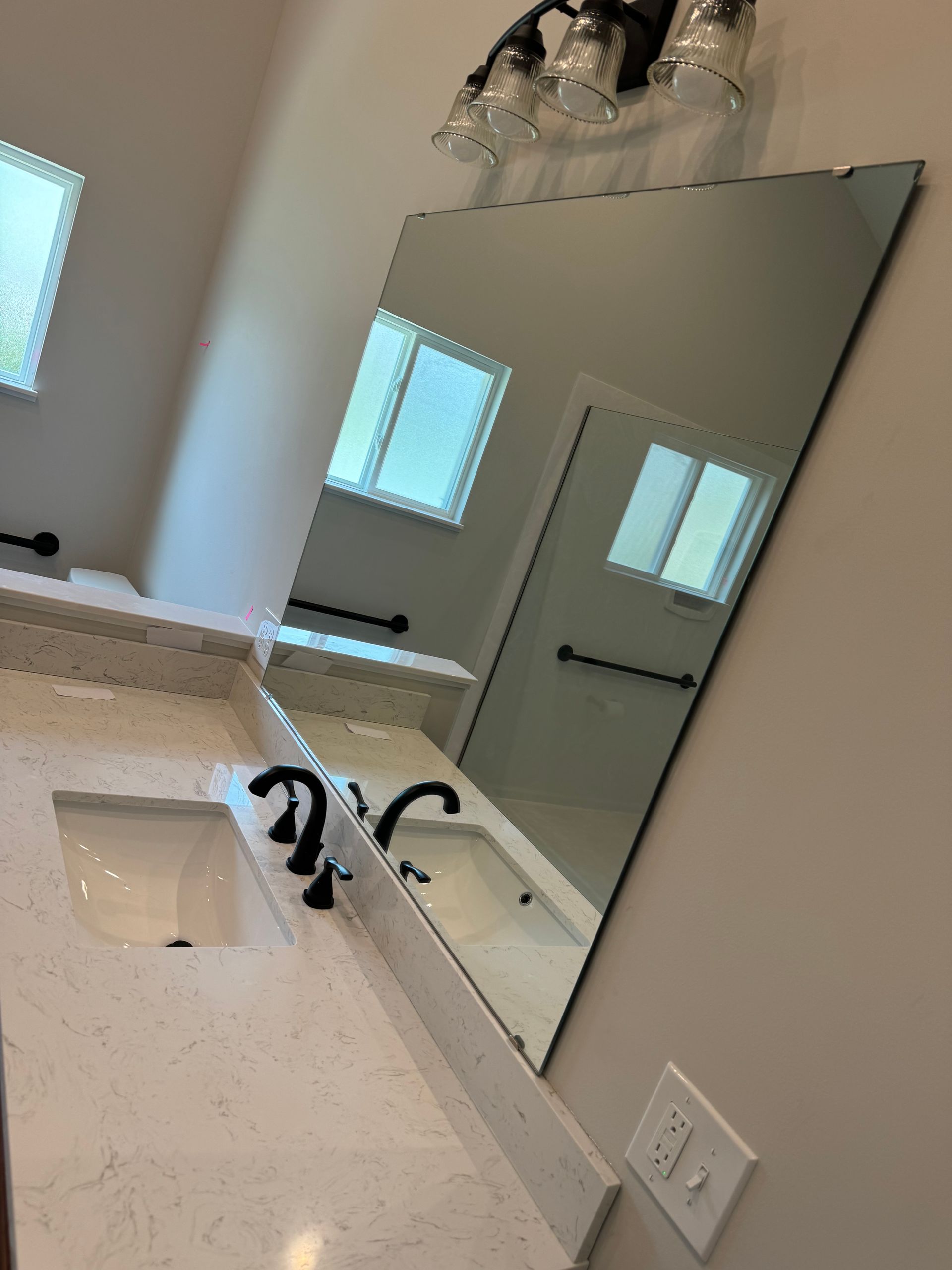 A bathroom with two sinks and a large mirror