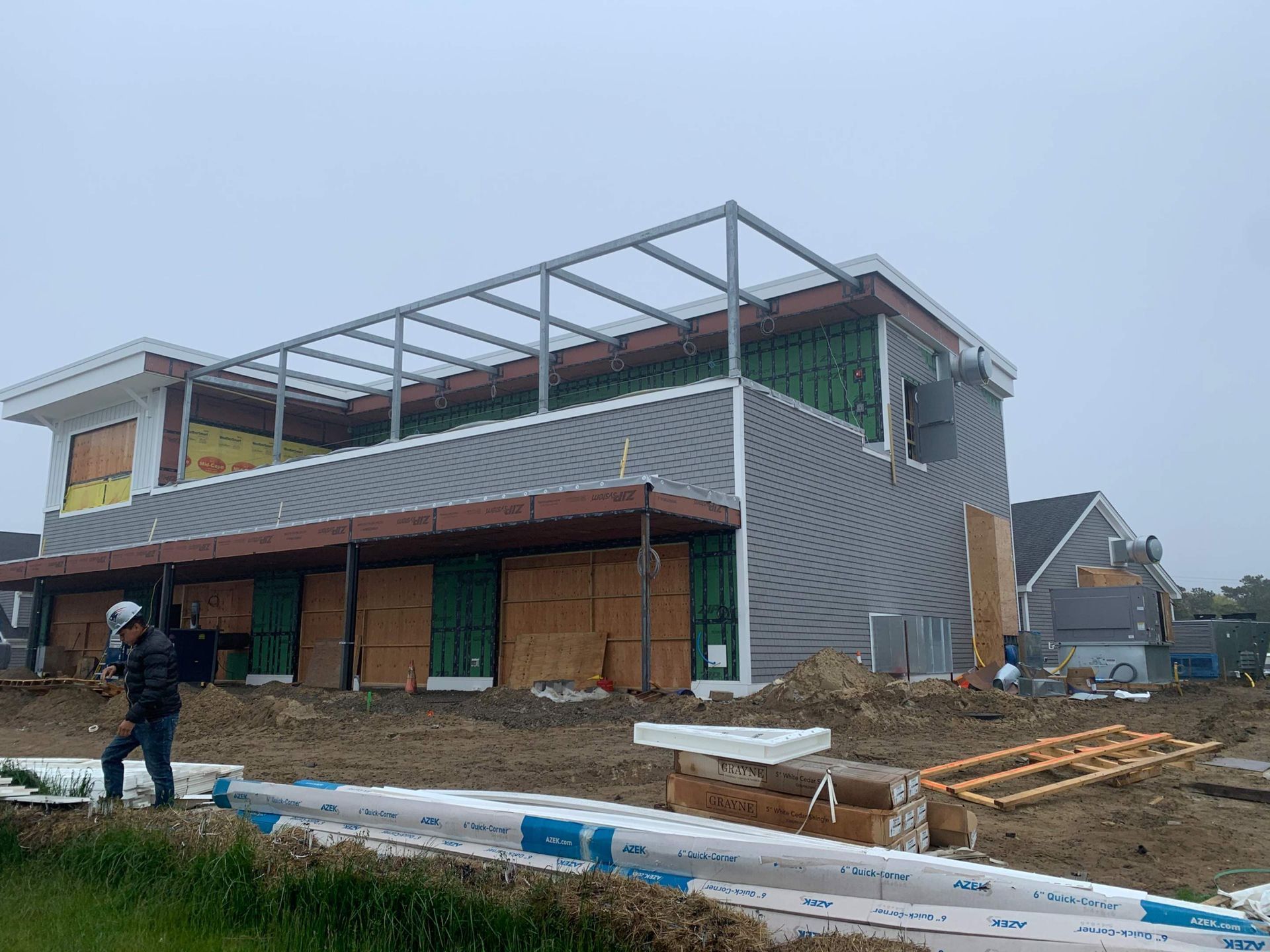 Construction of a two-story building on a cloudy day.