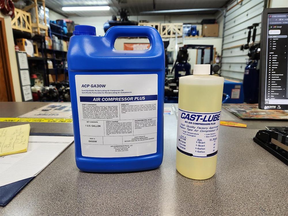 A bottle of cast-lube is next to a bottle of air compressor oil