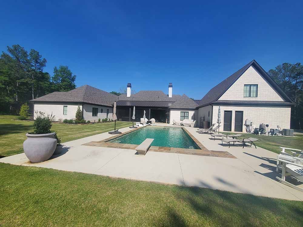 A large house with a large swimming pool in the backyard.