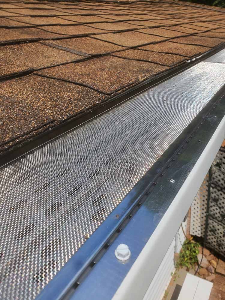 A close up of a gutter on top of a roof.