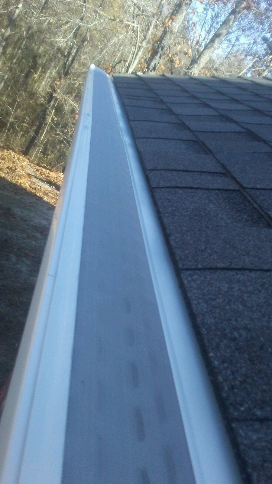 A close up of a gutter on a roof.