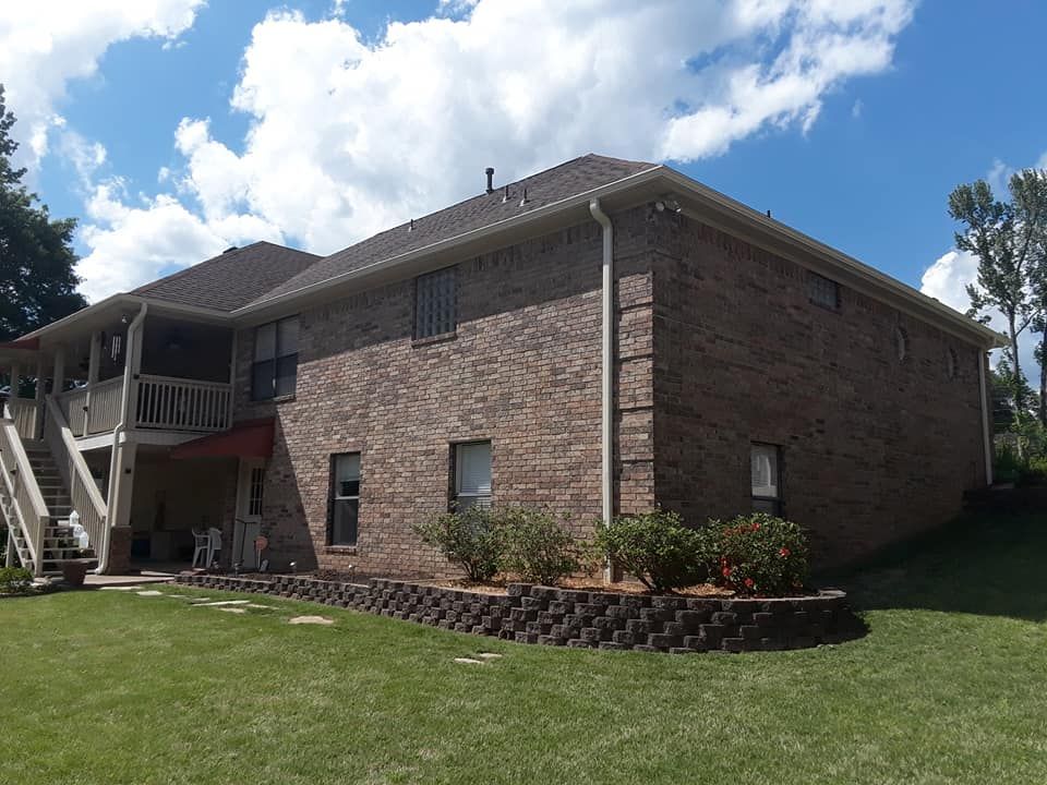 A large brick house with a balcony and stairs