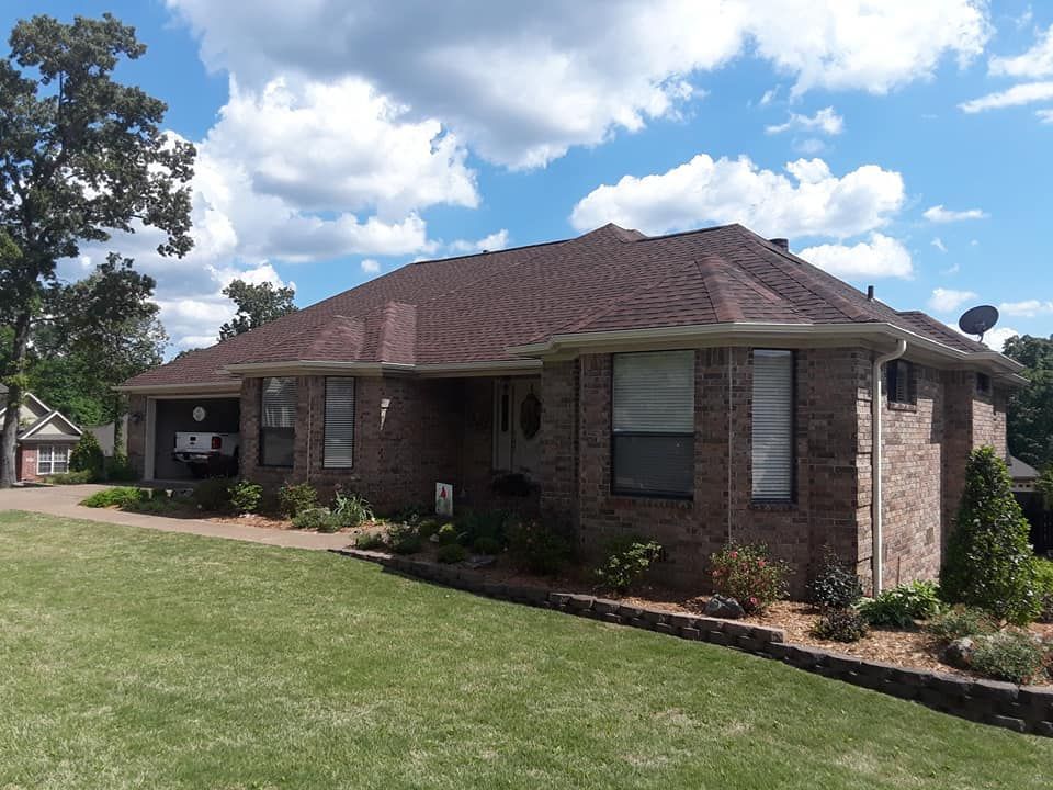 A brick house with a satellite dish on the roof