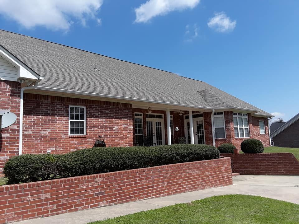A red brick house with a gray roof