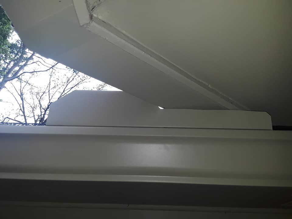 A white window with a tree in the background