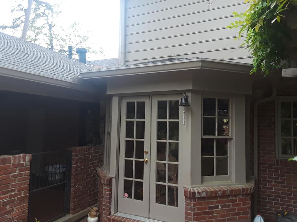 A brick house with a porch and french doors